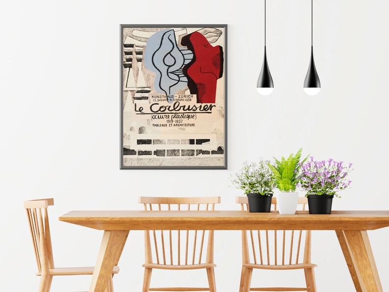May include: A framed poster with a black and white image of a building and a red and blue abstract design. The poster is titled "Le Corbusier" and includes the text "oeuvre plastique 1903-1937" and "TABLEAUX ET ARCHITECTURE".