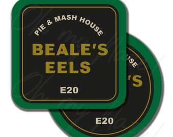 May include: Two coasters with a green border and a black center. The text on the coasters reads "PIE & MASH HOUSE" above "BEALE'S EELS" and "E20" in a gold font. One coaster is square, and the other is round.