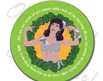 May include: A round, green sticker featuring a cartoon woman in a gray bikini, surrounded by a wreath of green leaves. The woman is smiling and wearing flower garlands. Text around the edge reads "And, you can wacka all you wanna while I hula all the day away."