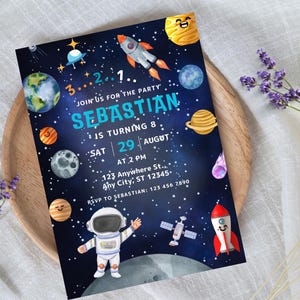 May include: A blue and black space-themed birthday party invitation with a cartoon astronaut, planets, and rockets. The invitation says "Join us for the party Sebastian is turning 8. Sat 29 August at 2 PM. 123 Anywhere St... Any City, ST 12345. RSVP to Sebastian: 123 456 7890"