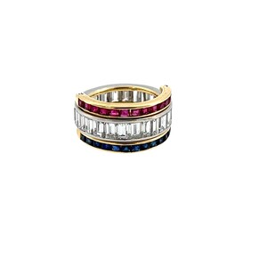 May include: A multi-band ring featuring three distinct rows of channel-set gemstones. The top row contains square-cut red rubies, the middle row features baguette-cut clear diamonds, and the bottom row consists of square-cut blue sapphires in gold.