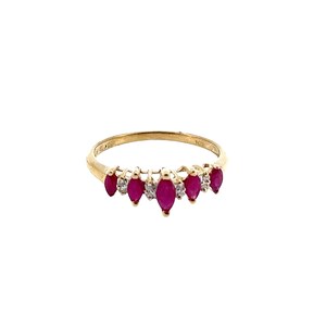 May include: A gold ring featuring a row of alternating marquise-cut red rubies and small round clear stones. The band is crafted from polished yellow gold, showcasing a delicate design where the gemstones are set in a continuous horizontal line.
