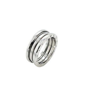 May include: A silver ring with three bands, each with a row of small, engraved numbers. The ring is a classic design and would make a great gift.