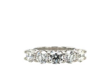May include: A silver band with six round, clear diamonds set in a row.