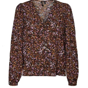 May include: A long-sleeved, V-neck blouse with a brown and black floral print. The blouse has a relaxed fit and a slightly gathered neckline.