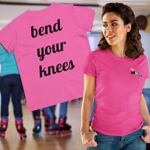 May include: Pink t-shirt with the text "bend your knees" printed on the back. The front of the shirt has a small graphic of a person on roller skates.