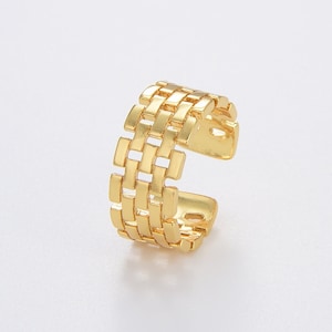 May include: A gold-toned adjustable ring with a woven, geometric design.