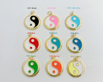May include: Nine gold-colored yin yang charms with different colored enamel fills. The colors are black, pink, light blue, red, teal, blue, green, orange, and yellow.