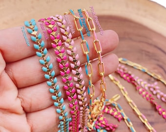 May include: Five gold chains with different colored enamel accents. The chains are arranged in a row, with the pink chain at the top and the turquoise chain at the bottom. The chains are all made of gold and have a chevron pattern. The chains are labeled with their colors: pink paperclip, blue paperclip, light pink, hot pink, and turquoise.