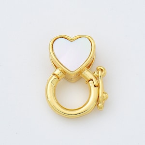 May include: Gold-toned heart-shaped clasp with a white mother-of-pearl inlay. The clasp is designed to be used as a connector for jewellery.