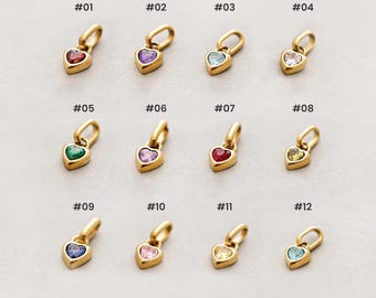 May include: A collection of twelve heart-shaped pendants with gold-colored settings and various colored gemstones. Each pendant is numbered from #01 to #12, with gemstones in red, purple, blue, clear, green, pink, and yellow.