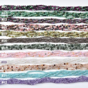 May include: A collection of twelve strands of gemstone beads in various colors. The beads are small and round, with colors ranging from deep purple and green to pink, white, and blue. Each strand is labeled with a number from #01 to #12.