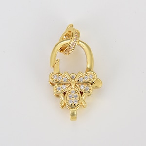 May include: Gold-tone butterfly clasp with clear crystal accents. The clasp is designed to be used for necklaces, bracelets, or other jewelry.
