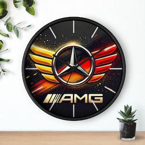 May include: Black and white clock with a gold and red Mercedes-Benz AMG logo with wings. The clock face has a black background with white numbers and hands. The words "AMG" are printed in white below the logo.