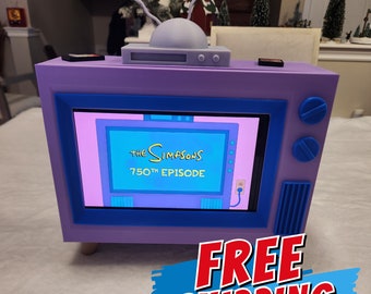 Station d'accueil pour téléviseur Simpsons pour Nintendo Switch avec espace de rangement - Peut contenir jusqu'à 4 étuis de jeu, manettes et plus