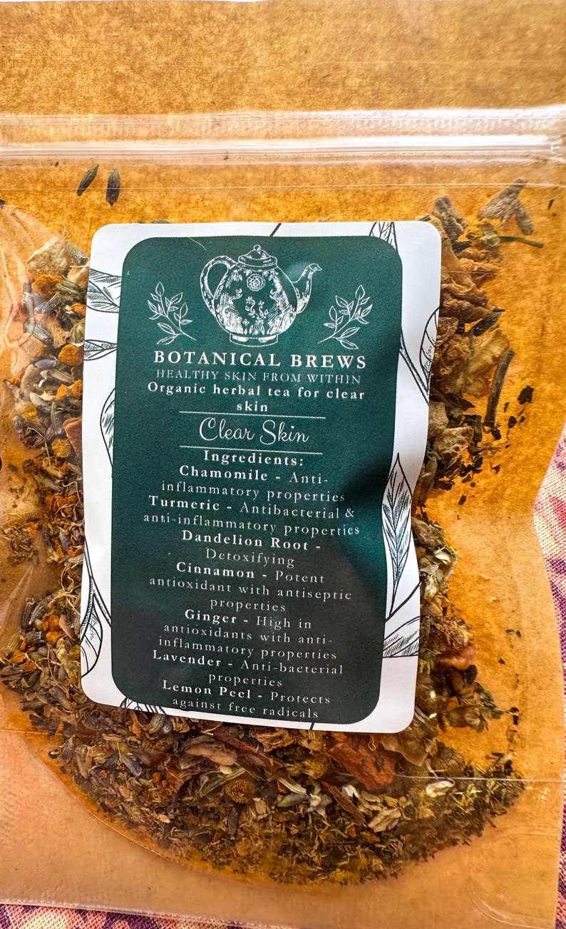 May include: A clear plastic bag filled with dried herbs and spices. A green and white label reads "Botanical Brews" and "Clear Skin." Ingredients include chamomile, turmeric, dandelion root, cinnamon, ginger, lavender, and lemon peel.