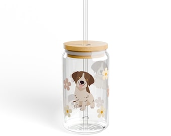 May include: A clear glass tumbler with a bamboo lid and a straw. The tumbler has a floral design with a brown and white dog illustration.