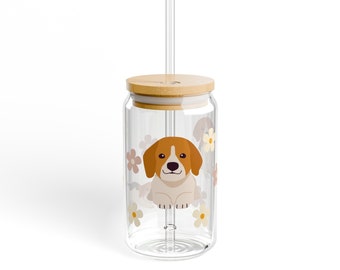 May include: A clear glass reusable drinking cup with a bamboo lid and a straw. The cup has a graphic of a beagle dog with flowers.