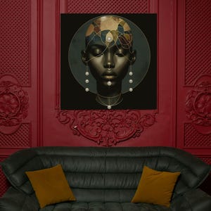 May include: A framed artwork featuring a stylized portrait of a person with dark skin. The portrait is set against a black background, with gold and pearl accents. The artwork hangs on a red wall above a black sofa with gold pillows.