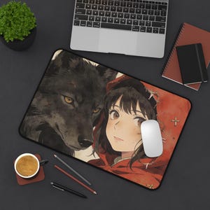 May include: A rectangular mousepad featuring an anime-style illustration of a girl in a red hood and a black wolf. The girl is winking, and the wolf is looking forward. The mousepad has a black border and a white mouse is on the pad.