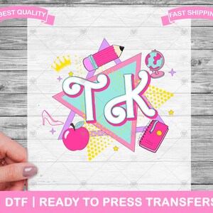 May include: A pink and blue graphic design with the letters "T.K." in a white circle. The design includes a pink pencil, a pink apple, a pink crown, a pink book, and a pink globe. The design is on a white background with a pink and blue geometric pattern.