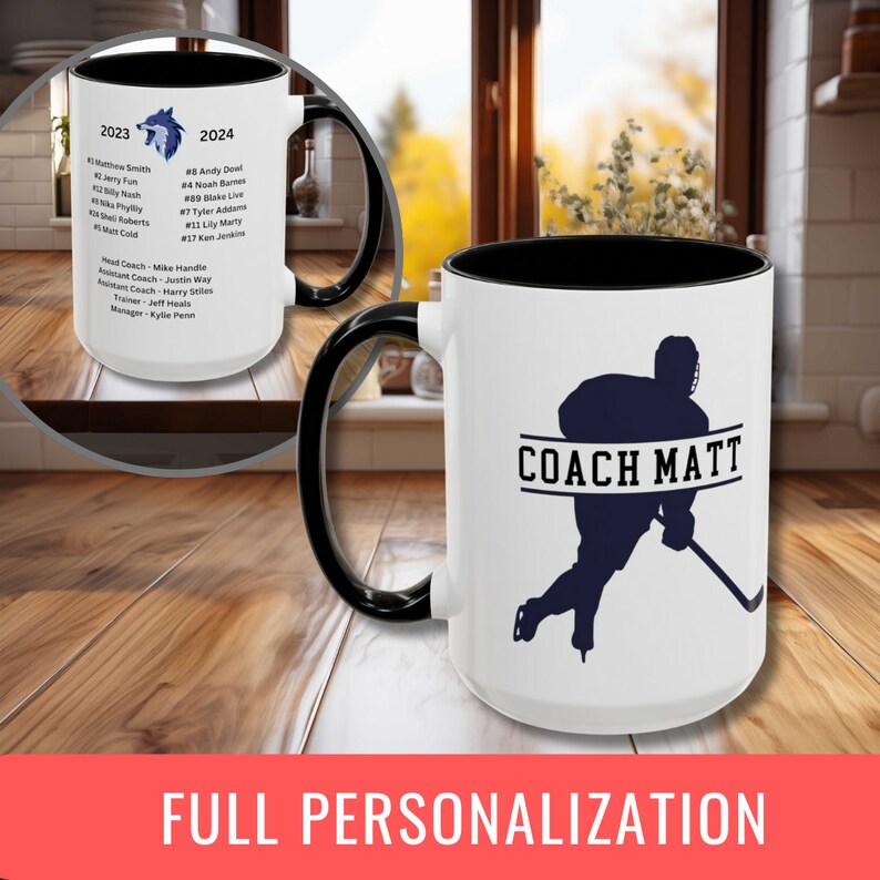 May include: White ceramic coffee mug with a black handle and rim. The mug has a blue silhouette of a hockey player with a stick and the text "COACH MATT" on the front. The back of the mug has a list of names and numbers, a wolf logo, and the years 2023 and 2024.