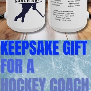 May include: White ceramic mug with a black handle. The mug has a black and blue hockey player silhouette with the text "COACH MATT" on it. The mug also has a list of hockey player names and numbers for the 2023 and 2024 seasons.