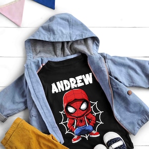 May include: Black t-shirt with a cartoon image of Spiderman wearing a red and blue suit. The shirt has the name "ANDREW" printed in white letters above the image.