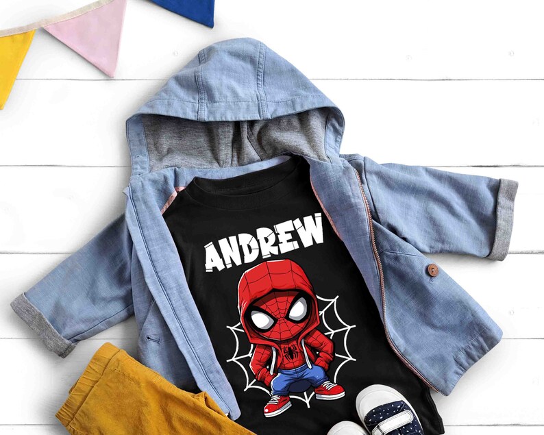 May include: Black t-shirt with a cartoon image of Spiderman wearing a red and blue suit. The shirt has the name "ANDREW" printed in white letters above the image.