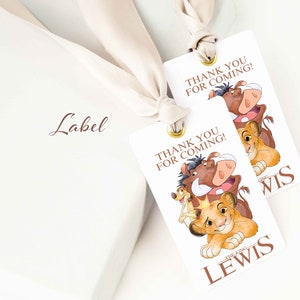 May include: Two white thank you tags with a lion king theme. The tags feature Simba, Pumbaa, and Timon. The text on the tags reads "Thank you for coming!" and "The King Lewis".