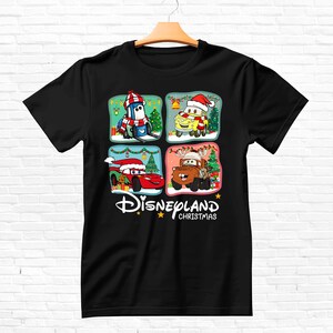 May include: Black t-shirt with a Christmas-themed design featuring characters from the Disney Pixar movie Cars. The design includes Lightning McQueen, Mater, and other characters in festive settings. The text "DISNEYLAND CHRISTMAS" is printed below the characters.