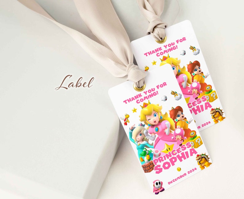 May include: Two pink and white favour tags with the text "Thank you for coming!" and a picture of Princess Peach and other characters from the Super Mario Bros. video game series. The text "Princess Sophia" and "December 2024" are also on the tags.