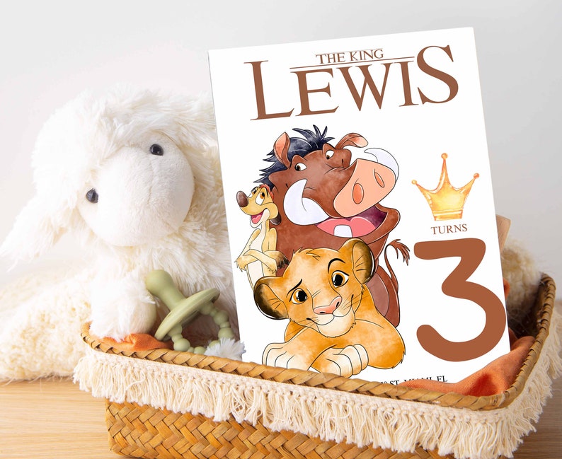 May include: A birthday card featuring the characters Pumbaa, Timon, and Simba from Disney's The Lion King. The card is white with brown text that reads "The King Lewis Turns 3". A gold crown is above the number 3.