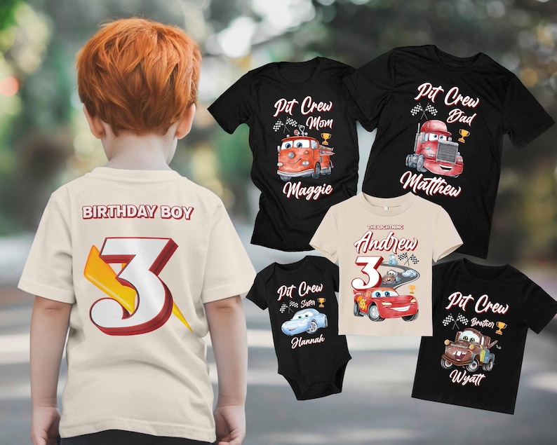 May include: A set of five black t-shirts with a Cars-themed design. The shirts feature a red race car, a red fire truck, and the text "Pit Crew" with different names. The shirts are for a family of five, including a birthday boy.
