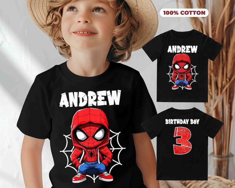 May include: Black t-shirt with a cartoon Spiderman design and the name "Andrew" printed in white. The shirt is 100% cotton.