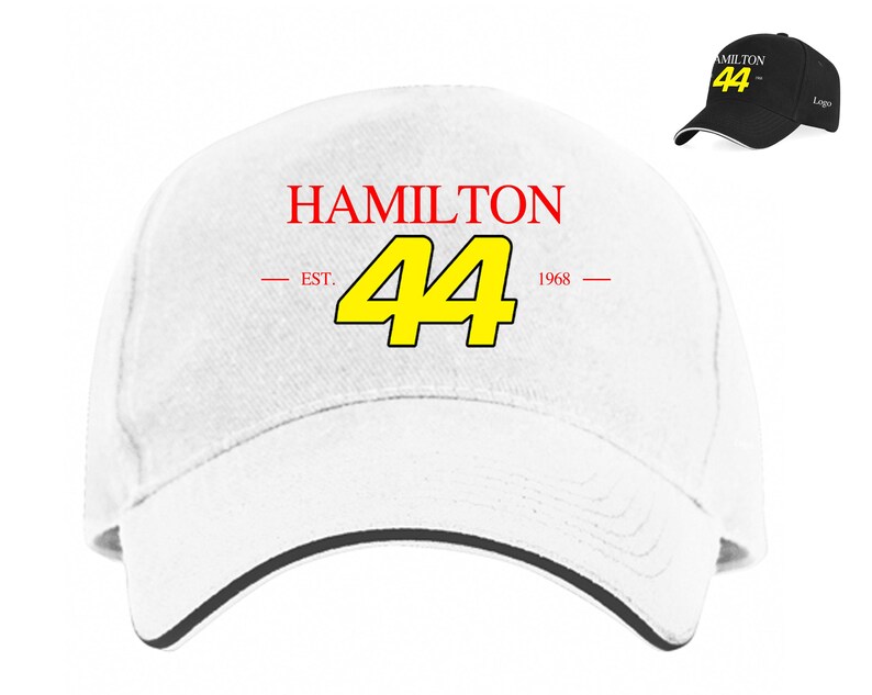 May include: White baseball cap with a black brim. The front of the cap has the text "HAMILTON" in red, "EST." and "1968" in red, and the number "44" in yellow.