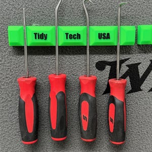May include: Four metal hook and pick tools with red and black handles are displayed on a green holder. The holder has the words "Tidy Tech USA" printed on it. The tools are designed for precision work.