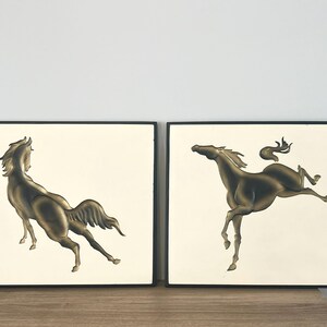 May include: A white ceramic mug with a black handle and the text "But First, Coffee" in a handwritten style. The mug is on a white surface. The mug is approximately 4 inches tall.