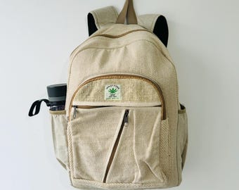 May include: A beige hemp backpack with a brown leather zipper pull and a green leaf logo that says "Himalayan Hemp" and "Eco-Friendly".