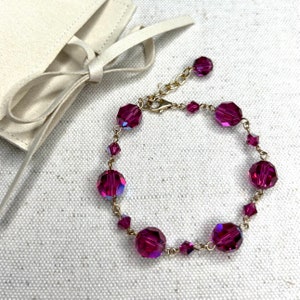Swarovski pink fuchsia crystal bead adjustable bracelet with gold hardware and ivory jewelry pouch