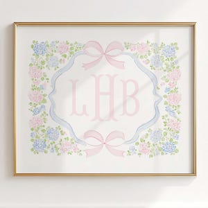 May include: A framed watercolor print featuring a monogram with the letters LHB in pink. The monogram is surrounded by a blue and pink floral design and two pink bows. The frame is gold.