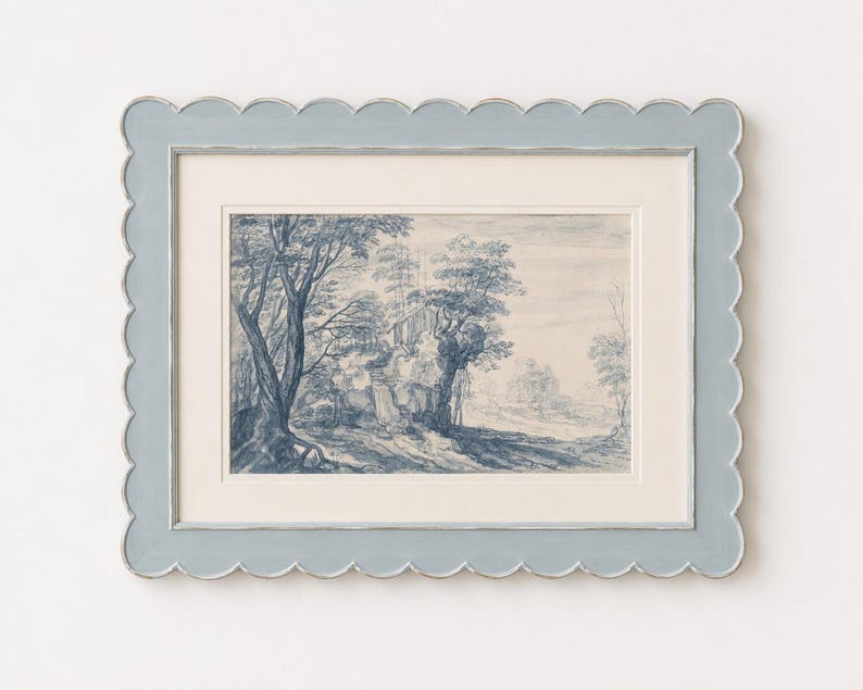 May include: A framed landscape print with a blue and white color scheme. The artwork depicts trees and a building in a forest setting. The frame is a light blue with a scalloped edge.