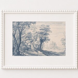 May include: A framed landscape art print featuring a detailed blue and white illustration of trees, a building, and a path. The artwork is set in a white frame with a beaded edge, creating a classic aesthetic.