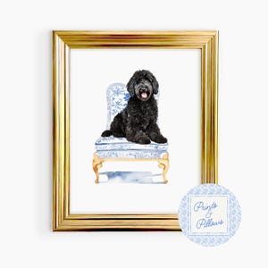 May include: A black dog sits on a blue and white patterned chair with gold accents. The chair has a floral design and the dog is looking at the camera. The image is framed in gold and has a watermark that says "Prints & Pillows".