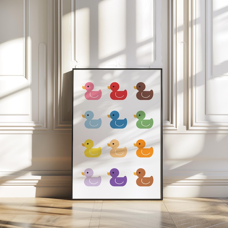 May include: A white poster with a grid of 12 colorful rubber duckies. Each duck is a different color, including pink, red, orange, yellow, green, blue, purple, and brown.