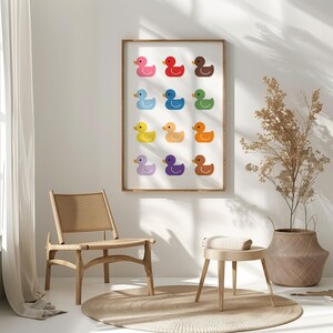 May include: A framed print of a colorful array of rubber duckies in various shades of yellow, orange, red, pink, purple, blue, and green. The duckies are arranged in a grid pattern on a white background.