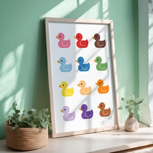 May include: A framed print of 12 colorful rubber duckies in a grid pattern. The ducks are arranged in a rainbow color order, starting with red and ending with purple.