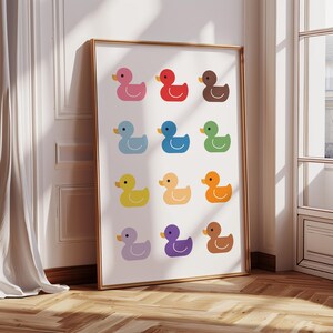 May include: A colorful print featuring 12 rubber duckies in a grid pattern. The ducks are in various colors, including red, blue, green, yellow, orange, purple, and brown.