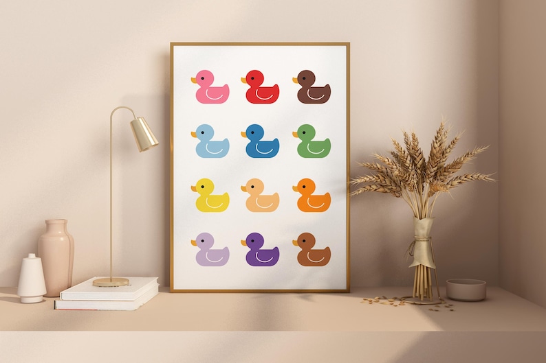 May include: A printable wall art design featuring a grid of 12 colorful rubber duckies. The ducks are arranged in a rainbow pattern, with each duck a different color.