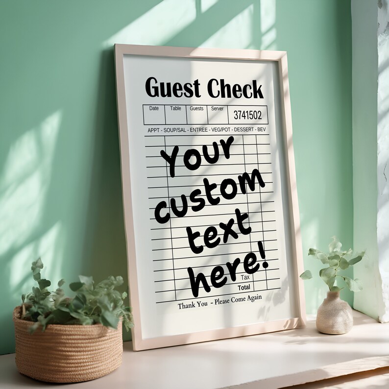 May include: A white framed sign with the text "Guest Check" and a blank check list with the text "Your custom text here!" printed on it. The sign is sitting on a white surface.